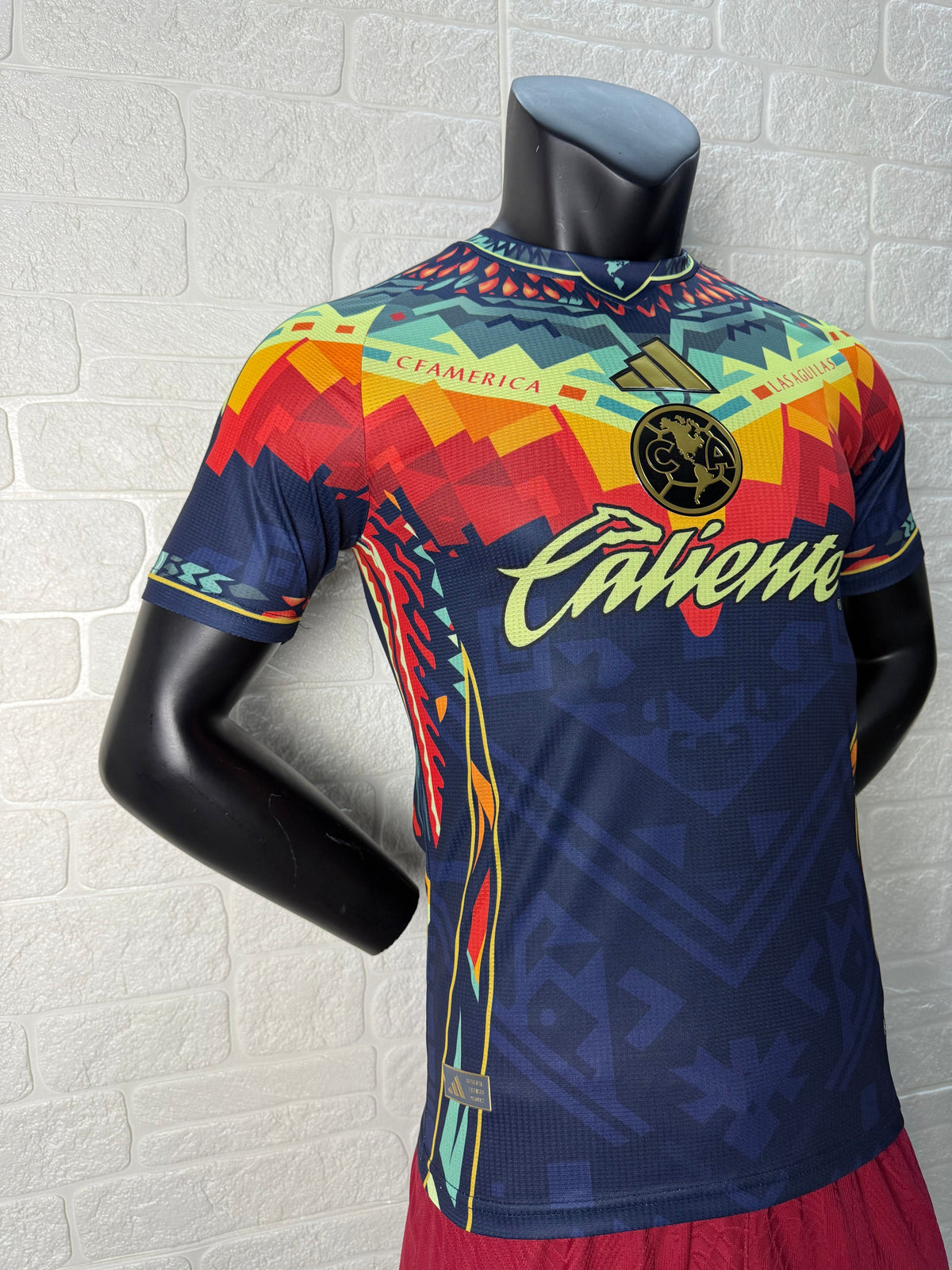2025/26 Club América Training Player Version Jersey - Dark Navy Blue Body Multicolour Aztec Zigzag Graphic Upper Chest  - Gold Three Stripes - Club América Crest - Caliente Principal Sponsor