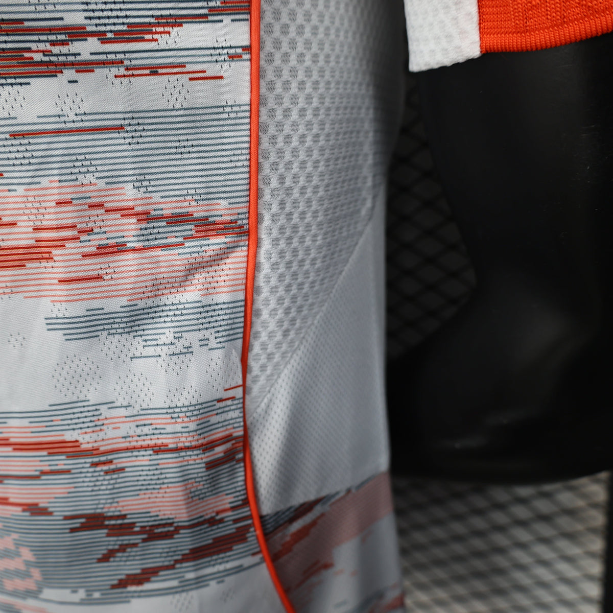 2025/26 Bayern Munich Away Player Version Jersey - White Body Red & Grey Horizontal Brushstroke Graphic - Orange Sleeve Cuffs - Black Adidas Three Stripes - FC Bayern Crest - Deutsche Telekom T Logo