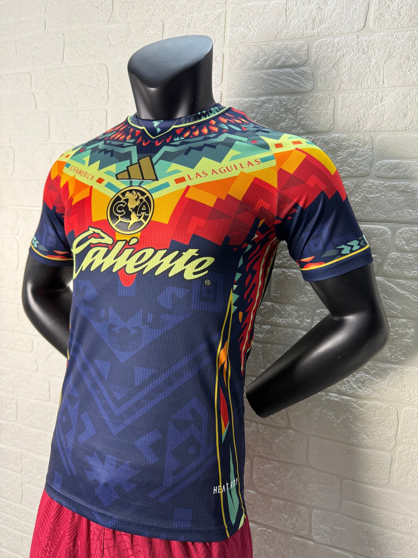 2025/26 Club América Training Player Version Jersey - Dark Navy Blue Body Multicolour Aztec Zigzag Graphic Upper Chest  - Gold Three Stripes - Club América Crest - Caliente Principal Sponsor