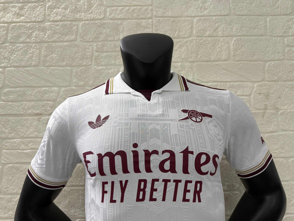 2025/26 Arsenal Third Player Version Jersey - White Body All-Over Subtle Tonal Graphic Texture Deep Maroon Polo Collar Gold Cream Stripe Trim Deep Maroon Sleeve Cuff Trim - Originals Trefoil - Arsenal Cannon Crest - Emirates Fly Better